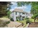 Back exterior view showcases a two-story home with backyard, landscaping and basketball hoop at 4085 Hillcrest View Ct, Suwanee, GA 30024
