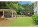 A backyard featuring an outdoor stone patio and a lush green lawn at 4085 Hillcrest View Ct, Suwanee, GA 30024