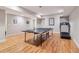 Finished basement with ping pong table and treadmill on hardwood floors and neutral paint at 4085 Hillcrest View Ct, Suwanee, GA 30024