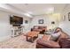Inviting finished basement with comfortable leather sofas, entertainment center and decorative rug at 4085 Hillcrest View Ct, Suwanee, GA 30024