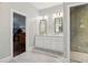 Bright bathroom featuring a double vanity, large mirror, and a walk-in shower at 4085 Hillcrest View Ct, Suwanee, GA 30024