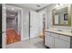 Bathroom featuring tile floors, vanity, gold accents, and a view of the hallway at 4085 Hillcrest View Ct, Suwanee, GA 30024