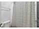 Bathroom with toilet and striped shower curtain at 4085 Hillcrest View Ct, Suwanee, GA 30024