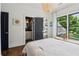 Bright bedroom with closet space, a view to the outside and an elegant pendant chandelier at 4085 Hillcrest View Ct, Suwanee, GA 30024
