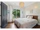 Airy bedroom boasting natural light, a pendant light fixture, and a tranquil ambiance at 4085 Hillcrest View Ct, Suwanee, GA 30024