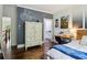Inviting bedroom with dark wood floors, a modern closet, and an artistic wall design at 4085 Hillcrest View Ct, Suwanee, GA 30024