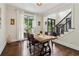 Traditional dining room with hardwood floors and views of the front yard and staircase at 4085 Hillcrest View Ct, Suwanee, GA 30024