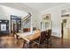 Open dining room with views of staircase and office space, wood table and chairs at 4085 Hillcrest View Ct, Suwanee, GA 30024