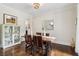 Dining room with wood table and chairs plus a white cabinet with glass doors at 4085 Hillcrest View Ct, Suwanee, GA 30024