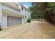Home features a long driveway with lush landscaping and a basketball hoop for outdoor activities at 4085 Hillcrest View Ct, Suwanee, GA 30024