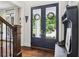 Bright entryway featuring elegant double doors, hardwood floors, and a sophisticated console table with decorative items at 4085 Hillcrest View Ct, Suwanee, GA 30024