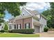 Beautiful brick house featuring manicured landscaping, a gray attached garage, and lush green trees surrounding the property at 4085 Hillcrest View Ct, Suwanee, GA 30024