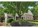 Beautiful brick home featuring manicured landscaping and a paved driveway leading to the welcoming front entrance at 4085 Hillcrest View Ct, Suwanee, GA 30024