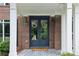 Welcoming covered front porch with stylish double doors, decorative wreaths, and an attractive patterned tile floor at 4085 Hillcrest View Ct, Suwanee, GA 30024