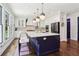 Spacious eat-in kitchen featuring a navy island, quartz countertops, stainless appliances, and seating for four at 4085 Hillcrest View Ct, Suwanee, GA 30024