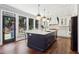 Bright eat-in kitchen with a large navy island, quartz countertops, stainless appliances, and a view to the backyard at 4085 Hillcrest View Ct, Suwanee, GA 30024