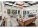 Stylish living room with fireplace, backyard views, and an open-concept kitchen at 4085 Hillcrest View Ct, Suwanee, GA 30024