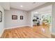 Bright living room featuring hardwood floors, white walls, and an open view to adjacent living spaces at 4085 Hillcrest View Ct, Suwanee, GA 30024