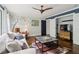 Bright living room with natural light, a ceiling fan, and modern furnishings at 4085 Hillcrest View Ct, Suwanee, GA 30024