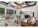 Bright living room with large windows overlooking landscaped backyard and outdoor space at 4085 Hillcrest View Ct, Suwanee, GA 30024