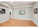 Spacious living room featuring hardwood floors, white walls, and natural light at 4085 Hillcrest View Ct, Suwanee, GA 30024