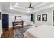 Spacious main bedroom featuring tray ceiling, hardwood floors and access to another room at 4085 Hillcrest View Ct, Suwanee, GA 30024
