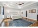 Spacious main bedroom featuring tray ceiling, hardwood floors and a stylish ceiling fan at 4085 Hillcrest View Ct, Suwanee, GA 30024
