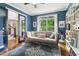Blue office with built-in bookcase, backyard view, and glass doors to entry at 4085 Hillcrest View Ct, Suwanee, GA 30024