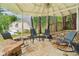 Covered outdoor patio with rocking chairs and stone flooring, perfect for entertaining at 4085 Hillcrest View Ct, Suwanee, GA 30024