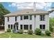 Two story home featuring light siding, ample windows, mature landscaping and private backyard at 4085 Hillcrest View Ct, Suwanee, GA 30024