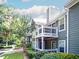 Apartment building exterior with balcony, green siding, and well-maintained landscaping at 510 Berkeley Woods Dr, Duluth, GA 30096