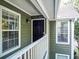 Front door entrance with green exterior and white railing, creating an inviting entry at 510 Berkeley Woods Dr, Duluth, GA 30096