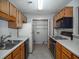 Functional kitchen with appliances, wood cabinets, and pantry, maximizing space and efficiency at 510 Berkeley Woods Dr, Duluth, GA 30096