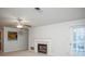 Bright living room featuring a fireplace, ceiling fan, and access to the balcony at 510 Berkeley Woods Dr, Duluth, GA 30096