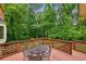 Back deck featuring a table and overlooking lush trees at 5524 Wedgewood Sw Ct, Lilburn, GA 30047