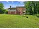 Expansive backyard with a large lawn, a screened porch and mature trees creating a private oasis at 5524 Wedgewood Sw Ct, Lilburn, GA 30047