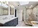 Modern bathroom featuring a double vanity, glass-enclosed shower, and wood-look flooring at 5524 Wedgewood Sw Ct, Lilburn, GA 30047