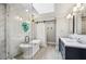Bright bathroom showcasing a soaking tub, glass shower, dual sinks, and modern fixtures at 5524 Wedgewood Sw Ct, Lilburn, GA 30047