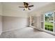 Clean and bright bedroom features neutral carpeting and two windows with shutter-style coverings at 5524 Wedgewood Sw Ct, Lilburn, GA 30047