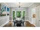 Elegant dining room showcasing hardwood floors, bay window, and modern lighting at 5524 Wedgewood Sw Ct, Lilburn, GA 30047