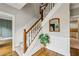 Classic foyer with hardwood floors, staircase, and white wainscoting, creating an inviting entrance at 5524 Wedgewood Sw Ct, Lilburn, GA 30047
