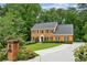 Inviting brick home with a manicured lawn, charming mailbox, and a long driveway at 5524 Wedgewood Sw Ct, Lilburn, GA 30047