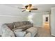 Comfortable living room featuring a large gray sectional sofa, ottoman, and soft carpeting at 5524 Wedgewood Sw Ct, Lilburn, GA 30047