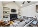 Spacious living room featuring custom built-ins, a fireplace, and comfortable seating at 5524 Wedgewood Sw Ct, Lilburn, GA 30047