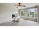 Bright office space with a white desk, natural light, and white horizontal shiplap accent wall at 5524 Wedgewood Sw Ct, Lilburn, GA 30047