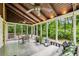 Comfortable screened porch with swing bed and dining area, perfect for outdoor relaxation at 5524 Wedgewood Sw Ct, Lilburn, GA 30047