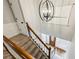 Elegant staircase with wood railing, neutral carpet, and a modern chandelier creates a welcoming ambiance at 5524 Wedgewood Sw Ct, Lilburn, GA 30047