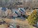 Aerial view of a beautiful brick home featuring a pristine lawn, mature trees and attached garage at 735 Amberton Close, Suwanee, GA 30024