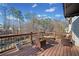 Back deck with dark wood stain, metal railing, and natural views at 735 Amberton Close, Suwanee, GA 30024