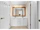 Bathroom with double sink vanity, large mirror, and white cabinets at 735 Amberton Close, Suwanee, GA 30024